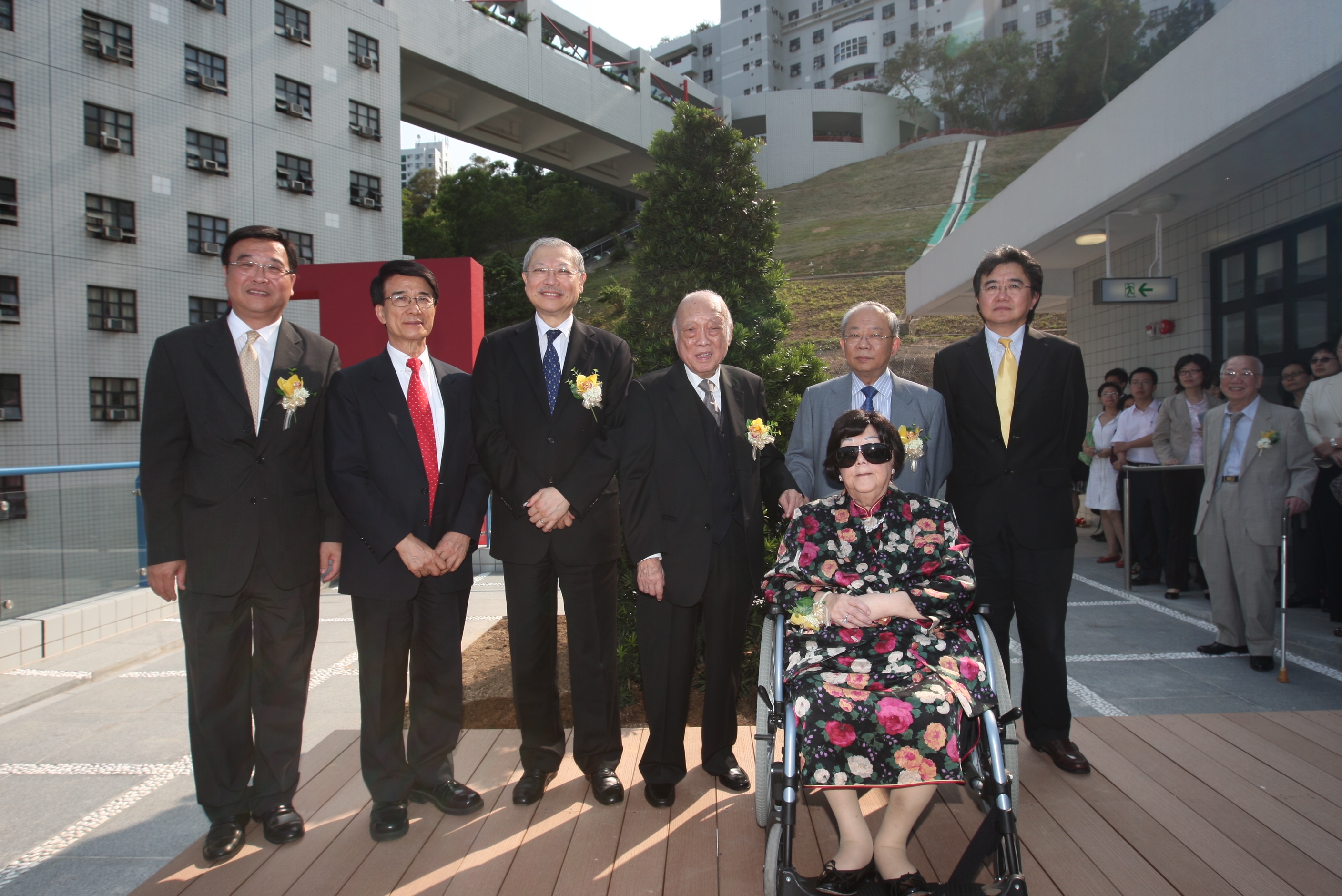 Officiating guests planting a pine tree on the podium of the new hall are (from left) Vice-President for Administration and Business Prof Yuk-Shan Wong, President Paul Chu, Secretary for Education the Hon Michael Suen, Dr Chan Sui-Kau, HKUST Court Chairman Dr John CC Chan, Vice-President for Academic Affairs Prof Roland Chin, and (at the front) Ms Chan Lam Moon Chun.	