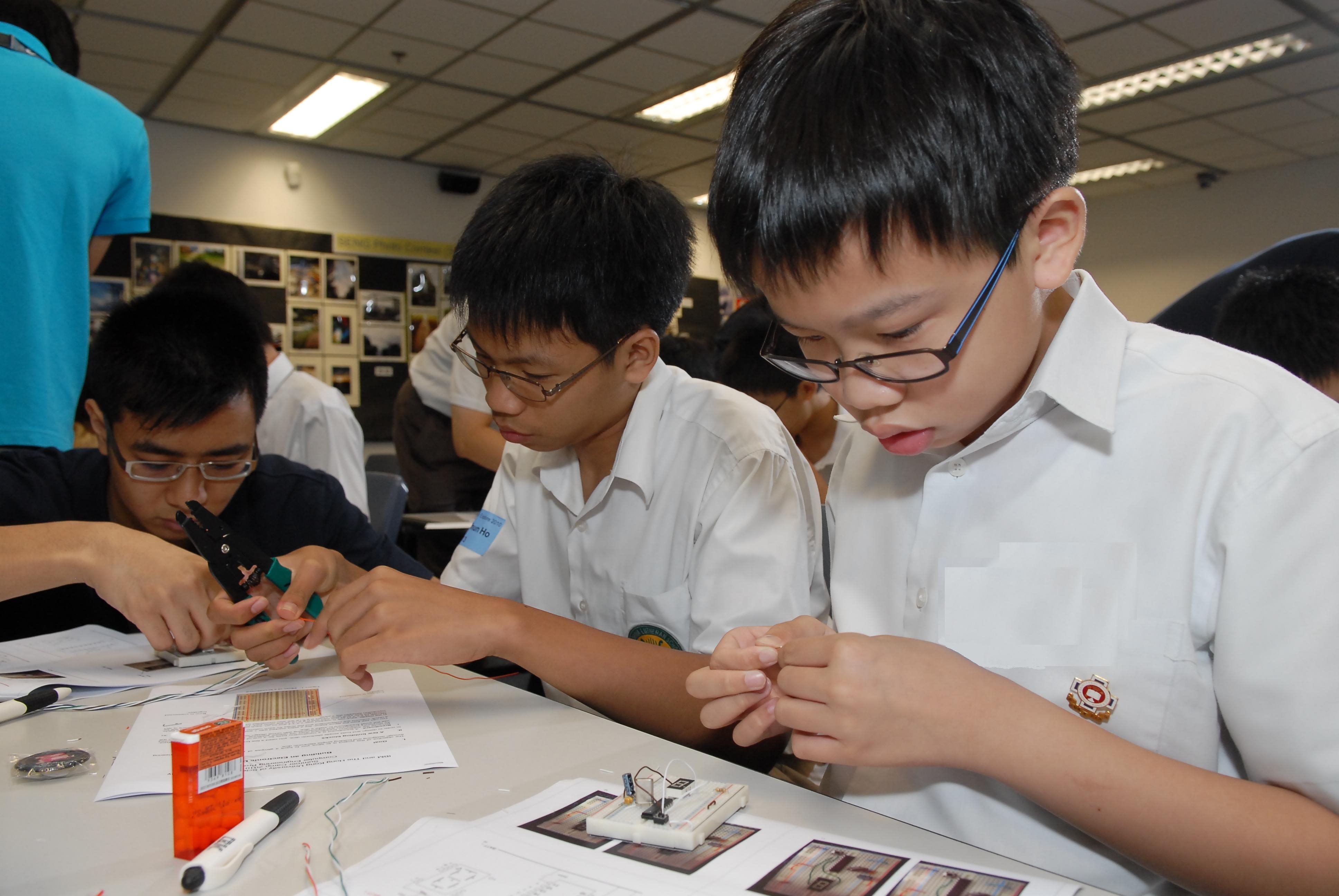 Students work with full concentration as they construct their own electronic dice.	