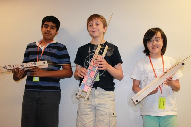 Students from different ethnic backgrounds showcasing their masterpieces – a magical car modified from a mouse trap	