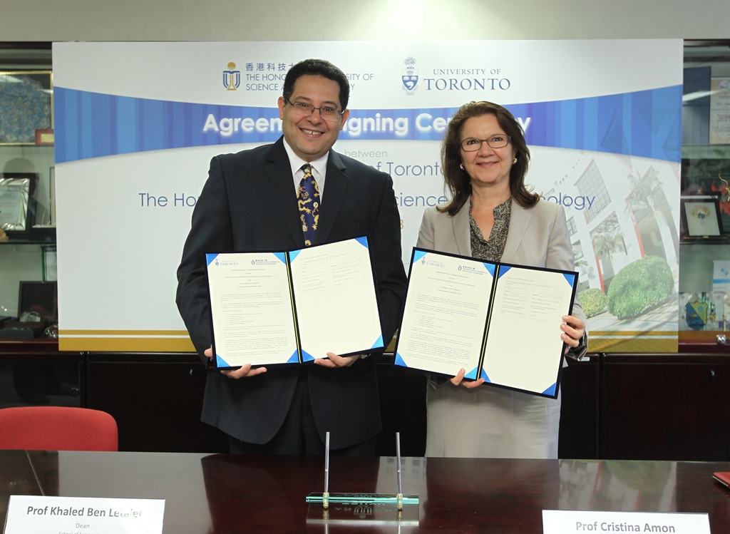  HKUST Dean of Engineering Prof Khaled Ben Letaief and U of T Dean of Faculty of Applied Science and Engineering Prof Cristina Amon sign the agreement at HKUST.