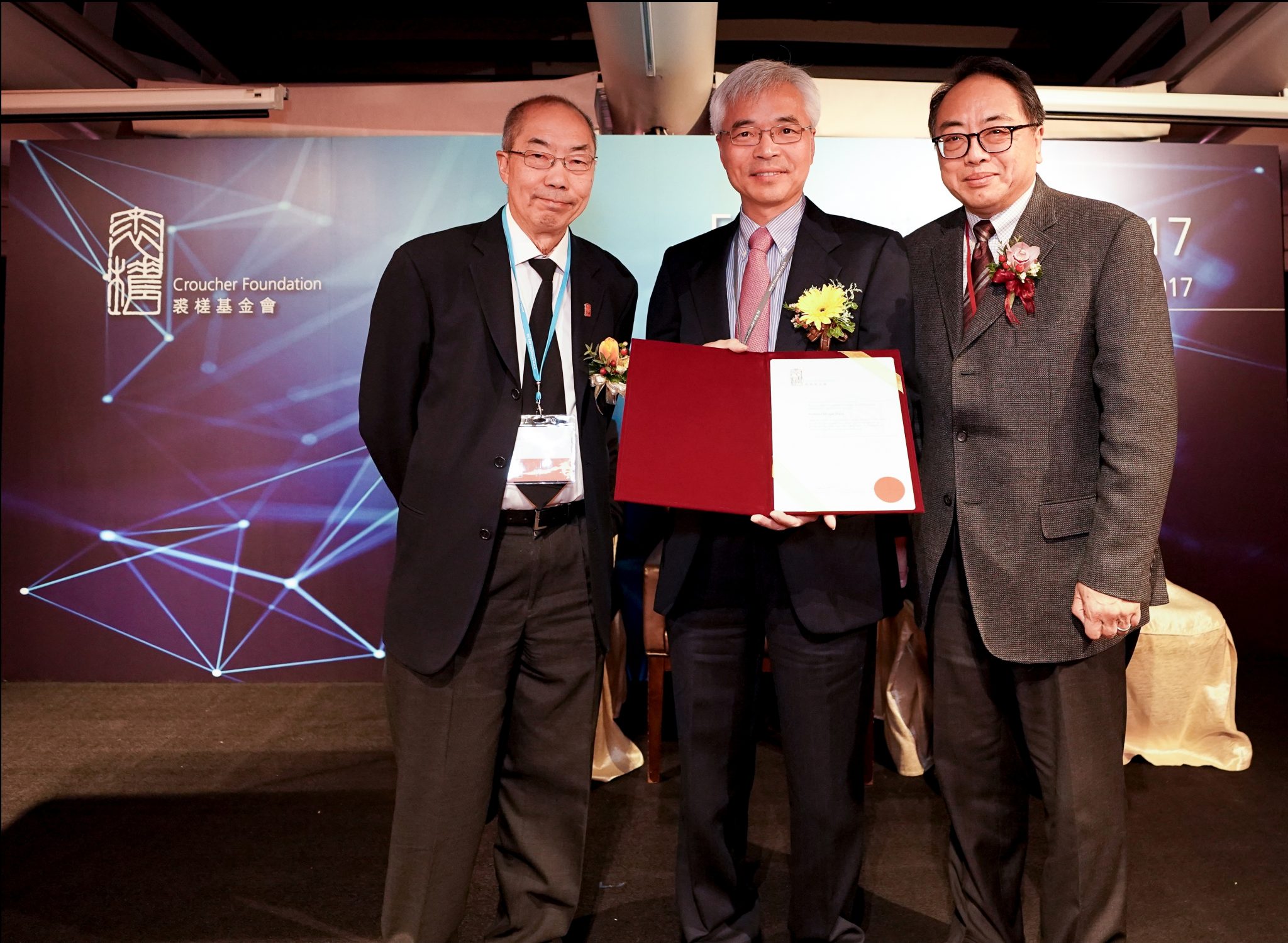  Prof Zhang receives Croucher Senior Research Fellowships 2018-2019 at the award ceremony from Prof Mak Tak-Wah (left), Chairman of Board of Trustees of the Croucher Foundation and Prof Lap-Chee Tsui, President of the Academy of Sciences of Hong Kong (right) Photo credit: Croucher Foundation